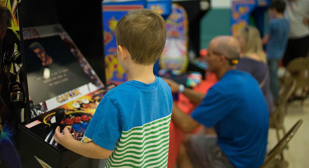 child playing arcade machine